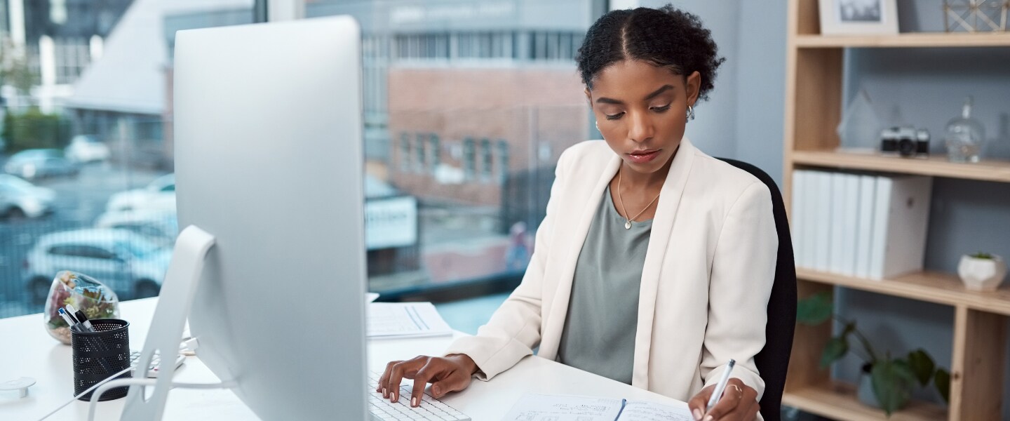 Woman reviews notes while preparing taxes in Texas.