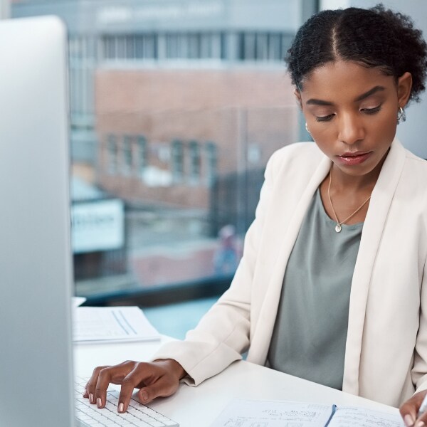 Woman reviews notes while preparing taxes in Texas.