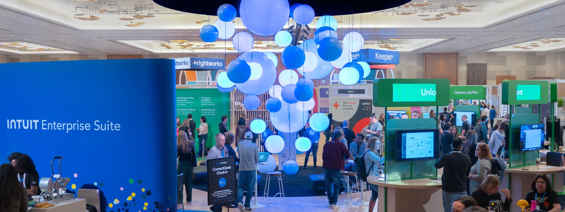 A group of people standing around a room with blue walls.