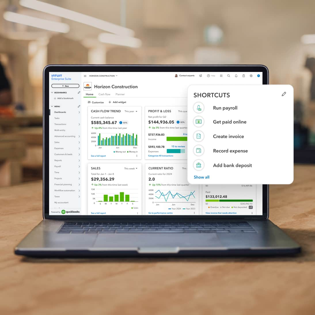 Intuit Enterprise Suite shortcuts appear on a laptop screen. 