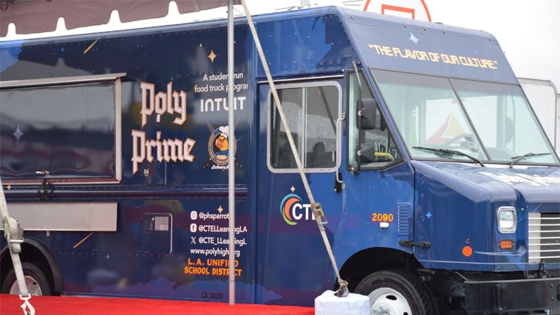 A food truck parked in a parking lot.