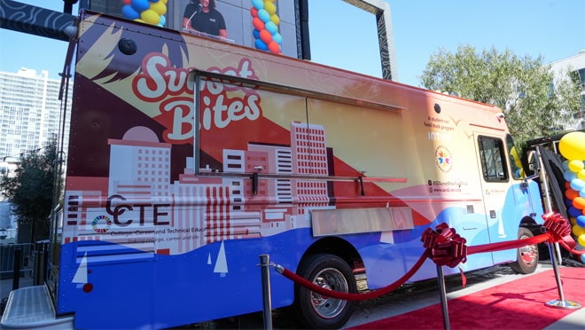 A large truck with a large advertisement on the side.