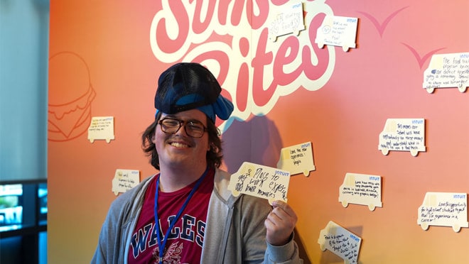 A person wearing a hat with a bunch of fake ties on his head.