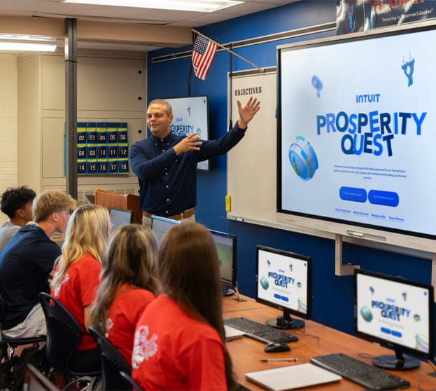 A person standing in front of a laptop computer.