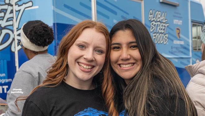 Two people smiling and posing for a picture.