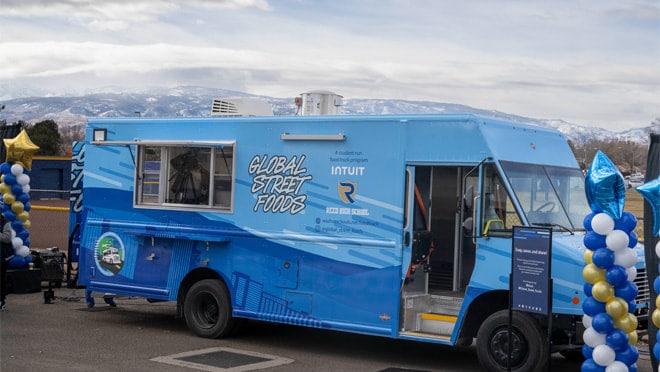 A blue truck parked in a parking lot.