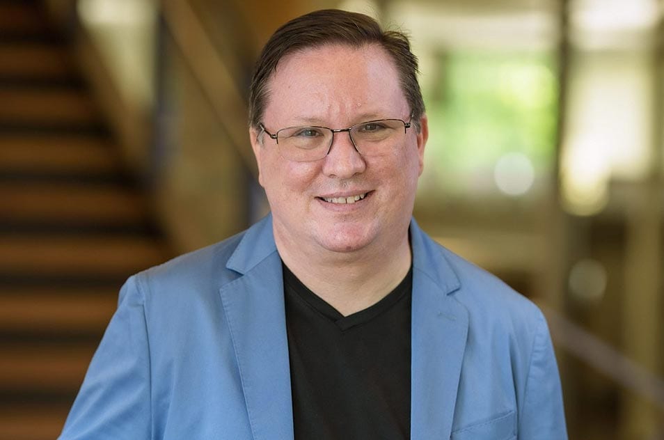 A person wearing glasses and a neck tie.