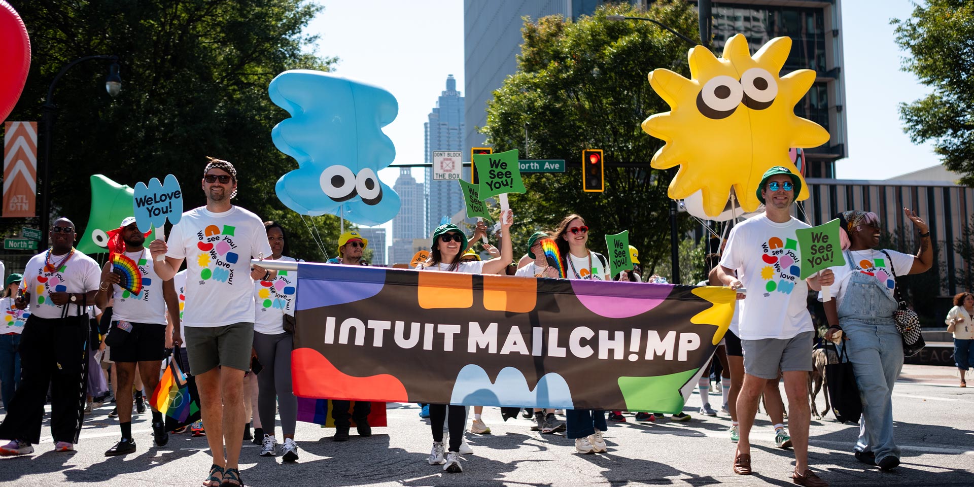 A large group of people holding up colorful signs.